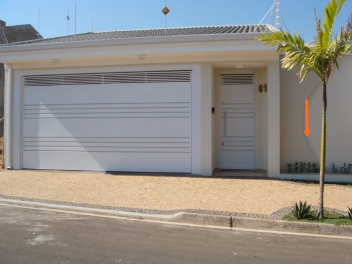 Composição de porta e portão metálico em fachada residencial